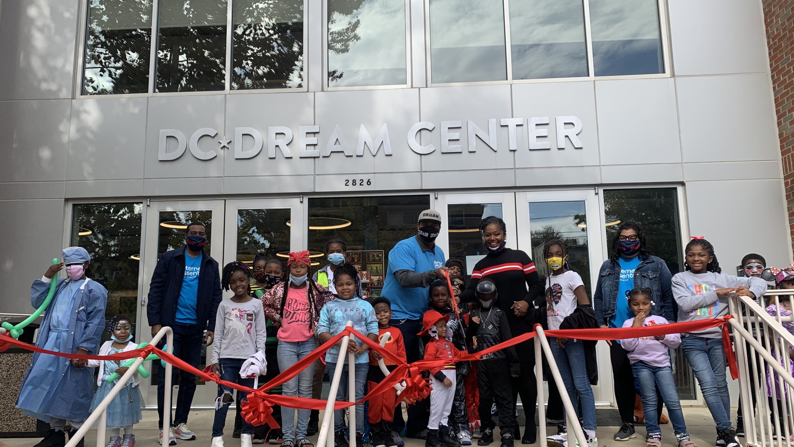 A group of people standing in front of The DC Dream Center.