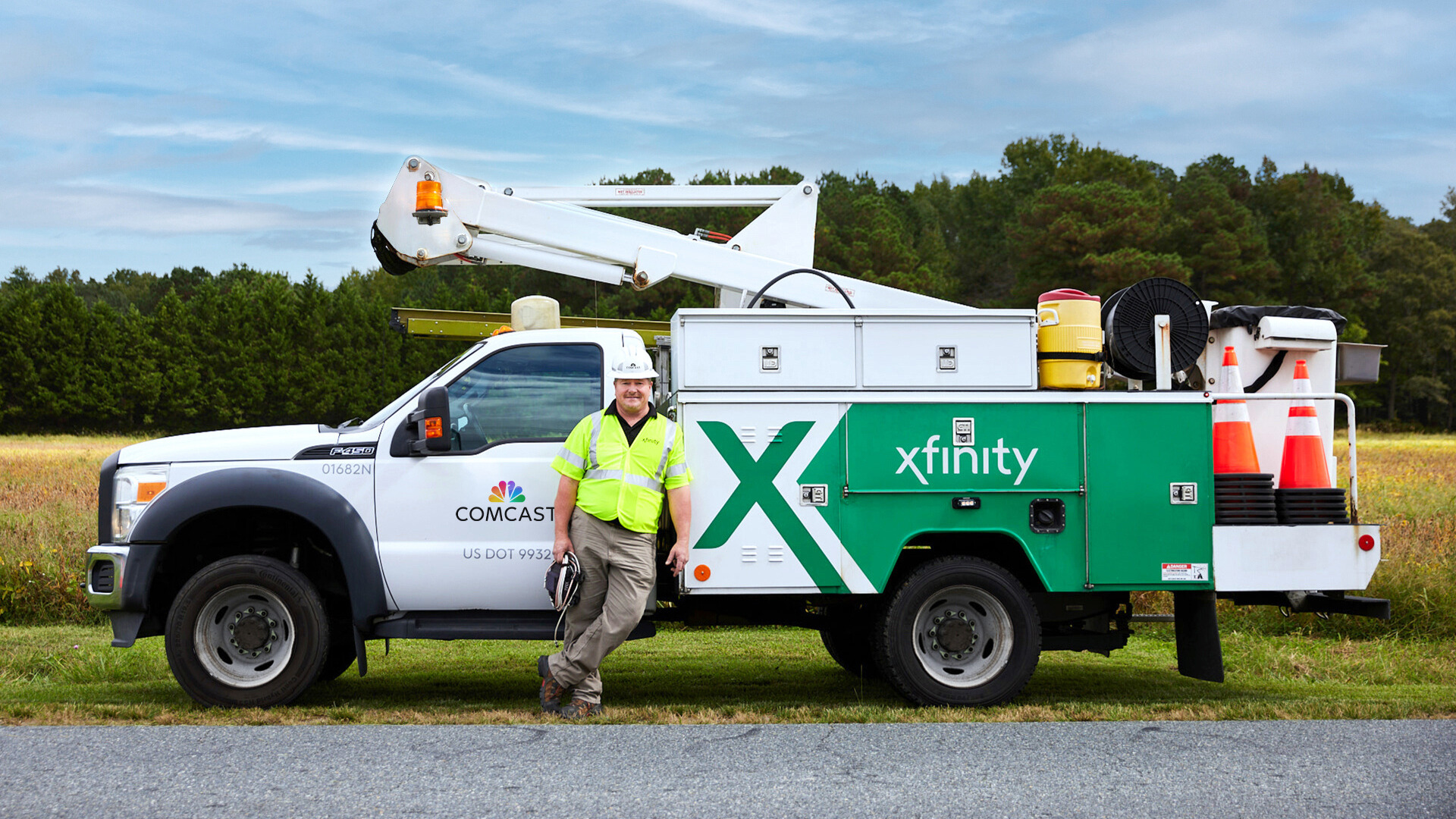Technician standing in front of an Xfinity truck.