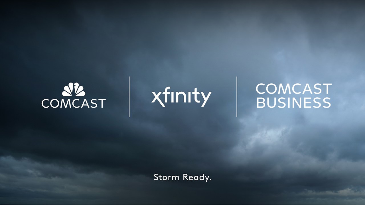 Comcast logo, Xfinity logo and Comcast Business logo in white agains a stormy sky